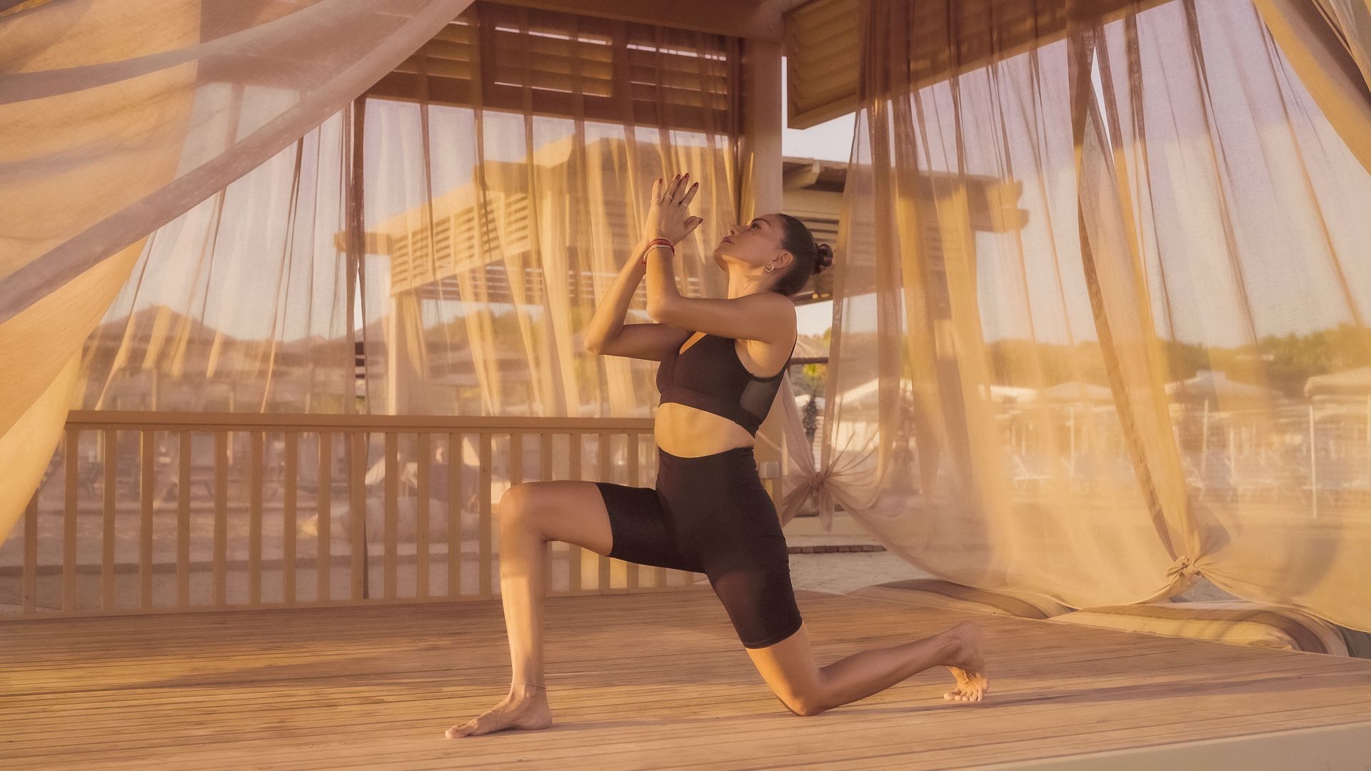 Liu Resorts | Woman in black workout clothes doing yoga