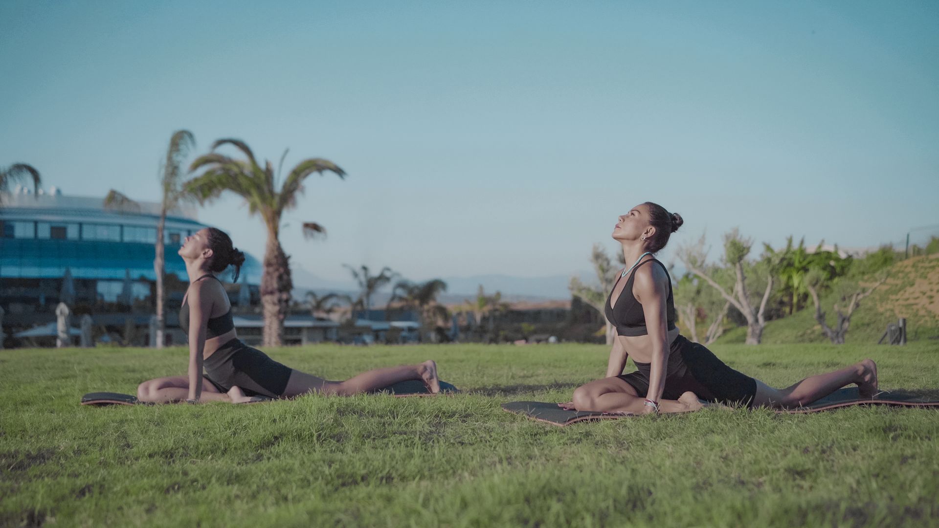 Liu Resorts | Two people doing yoga outside