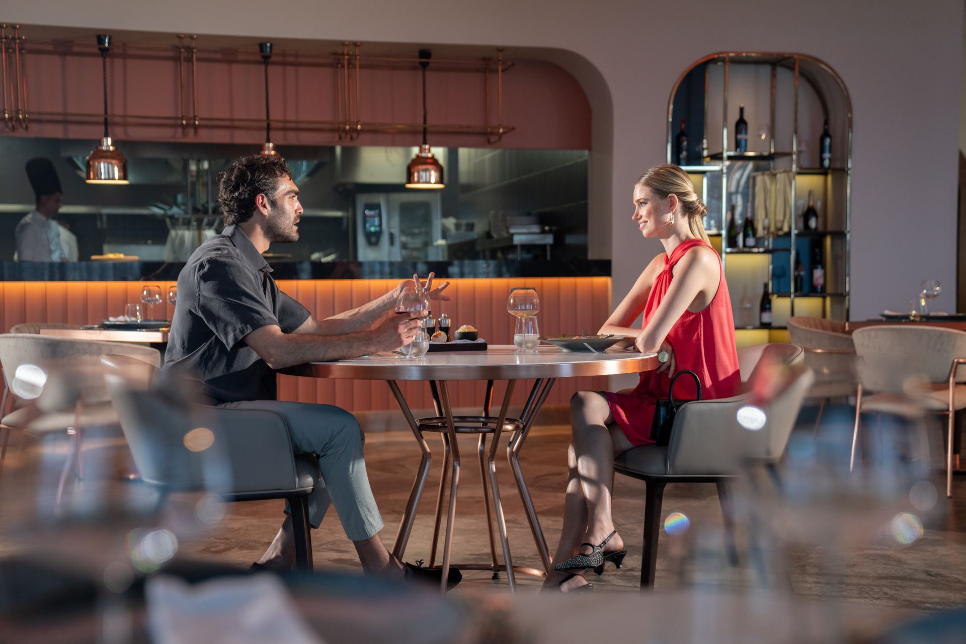 Liu Resorts | Couple at a restaurant table, engaged in conversation. 